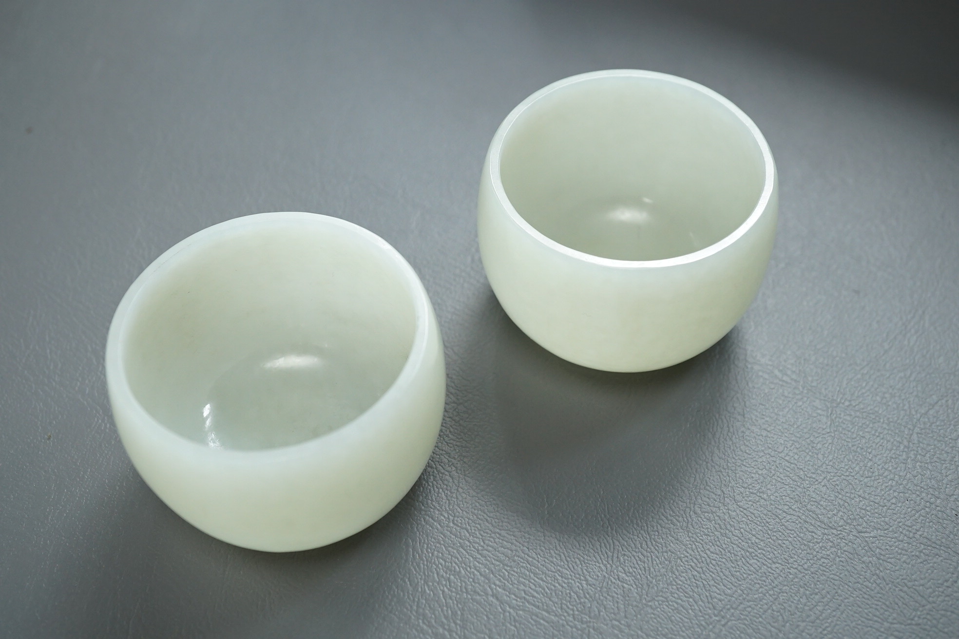 A pair of Chinese white jade cups, Qing dynasty or later